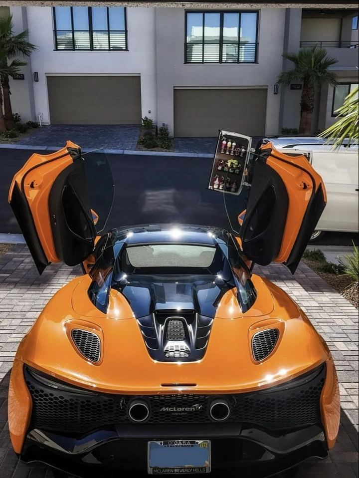 Orange McLaren with doors up after an exterior and interior detail